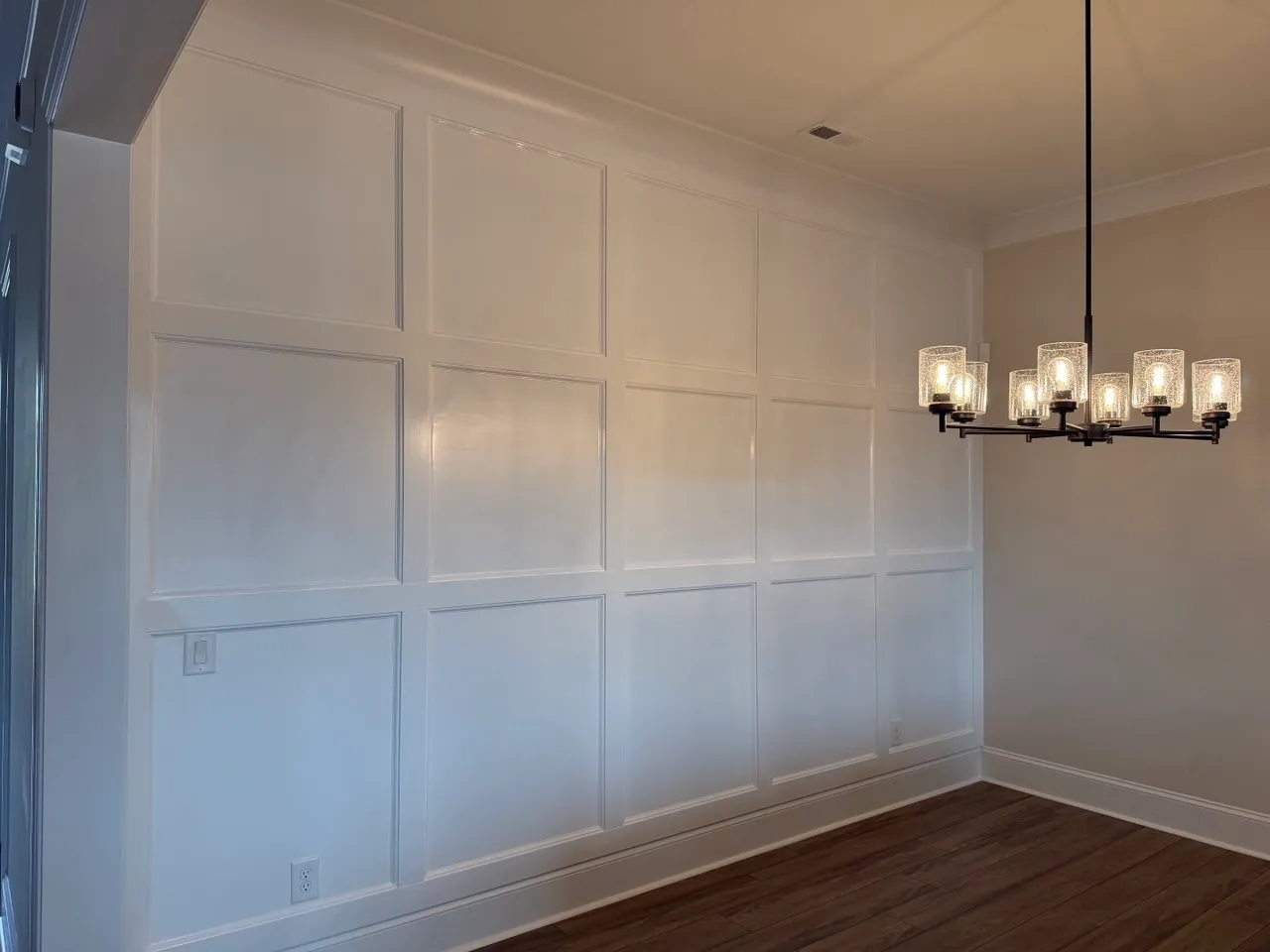 White box molding grid on a dining room wall